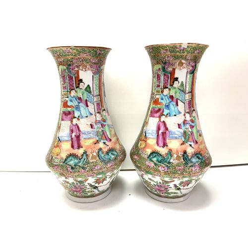 988 - A pair of Cantonese porcelain baluster shaped vases. 25cm (D) some damage to rim.