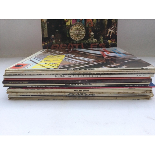 129 - A bag of Beatles and related LPs including early UK pressings of 'Revolver' and 'Sgt Pepper'.