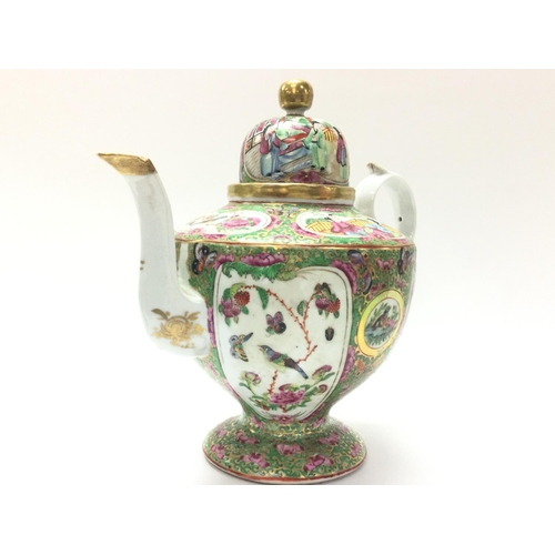 1111 - A Cantonese Famille Rose tea pot and vase. Chips at the rim of the vase and at the base. Approximate... 