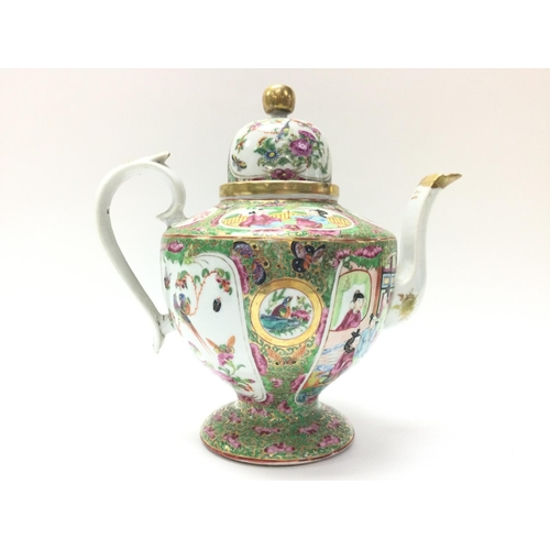 1111 - A Cantonese Famille Rose tea pot and vase. Chips at the rim of the vase and at the base. Approximate... 