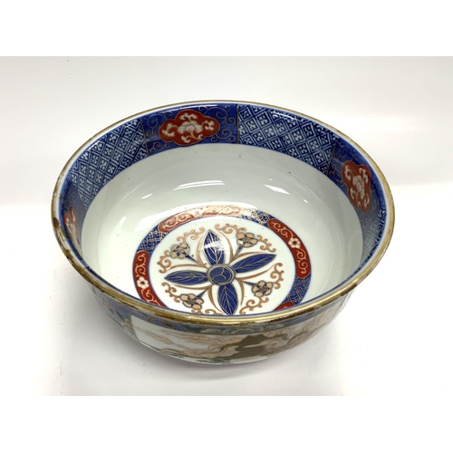 1126 - A Japanese Imari bowl, 19th century, decorated with scenes of Mount Fuji and Dragons. 22cm x 10.5cm.... 