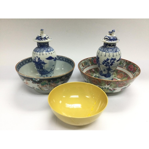 1148 - A pair of blue and vases and covers, a famille rose bowl and two other bowls. Some damages. Shipping... 