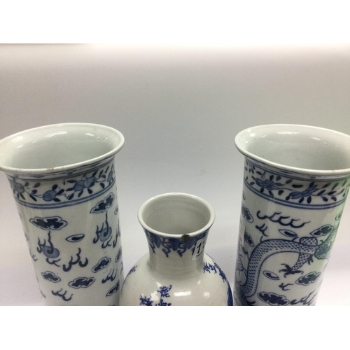 1157 - Three blue and white Oriental vases comprising a pair decorated with a dragon chasing a pearl approx... 