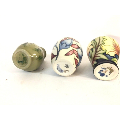 1240 - A collection of three small Moorcroft vases. Largest is approximately 10cm tall by 8cm wide. Postage... 