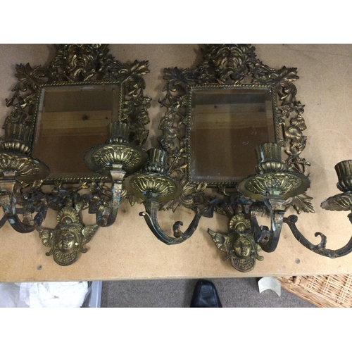 933 - A pair of gilt metal wall mirrors of classical style with three branch candelabra 44 cm 25 cm .