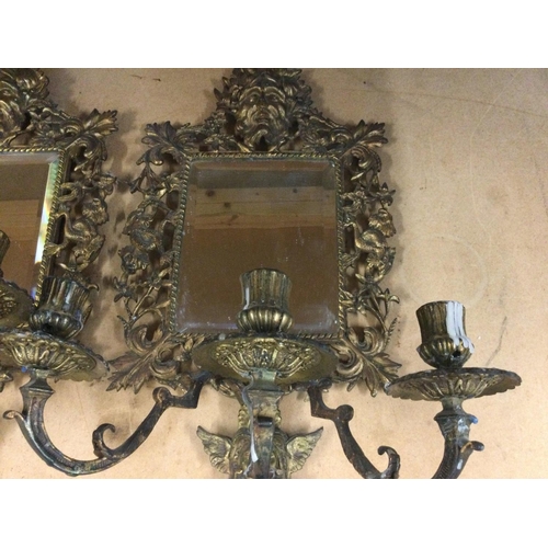 933 - A pair of gilt metal wall mirrors of classical style with three branch candelabra 44 cm 25 cm .