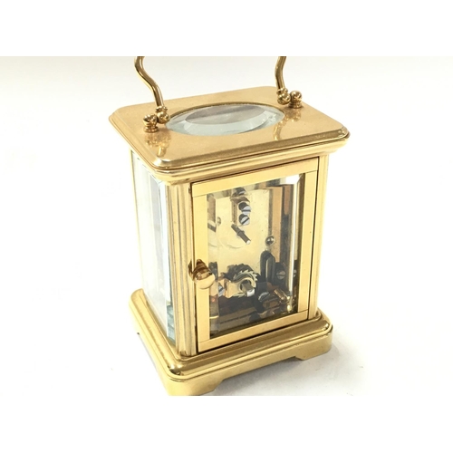 935 - A small brass carriage Halcyon Days Enamels clock. Postage category D