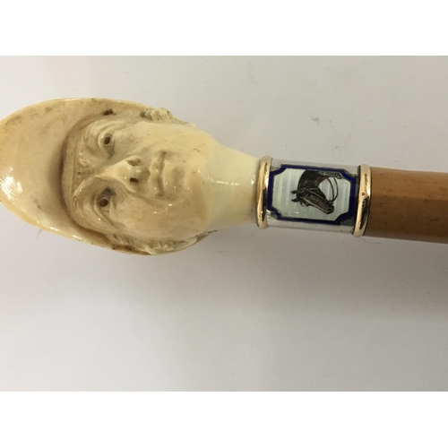 936 - A 1930s or earlier walking stick with a carved ivory top in the form of a jockeys head with a gold r... 