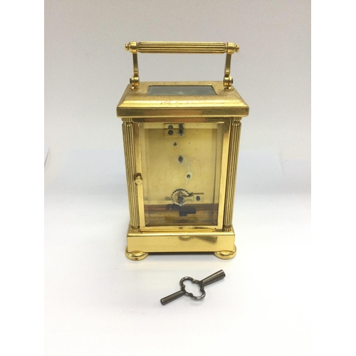 947 - A brass cased carriage clock with key. Shipping category D.