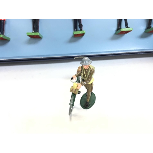 242 - A Collection of Boxed Britains Soldiers. Including Band Of The Life Guards #00157. Walking Cyclist #... 