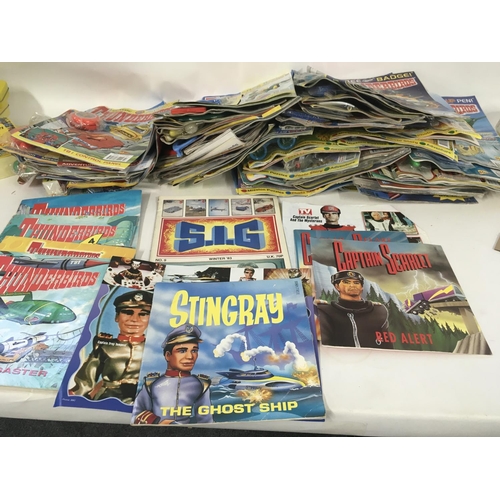 31 - A collection of thunderbirds and Captain scarlet toys. Also Thunderbirds magazine comics the majorit... 