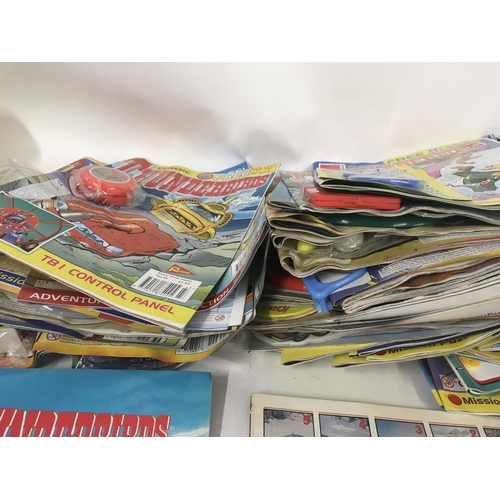 31 - A collection of thunderbirds and Captain scarlet toys. Also Thunderbirds magazine comics the majorit... 