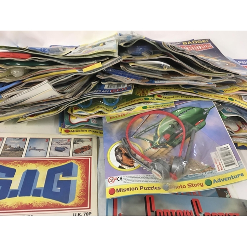 31 - A collection of thunderbirds and Captain scarlet toys. Also Thunderbirds magazine comics the majorit... 