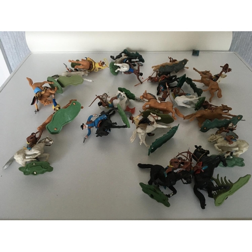 375 - A collection of 19 plastic mounted cowboys and Indians by Herald and Britains. Also includes 4 bags ... 