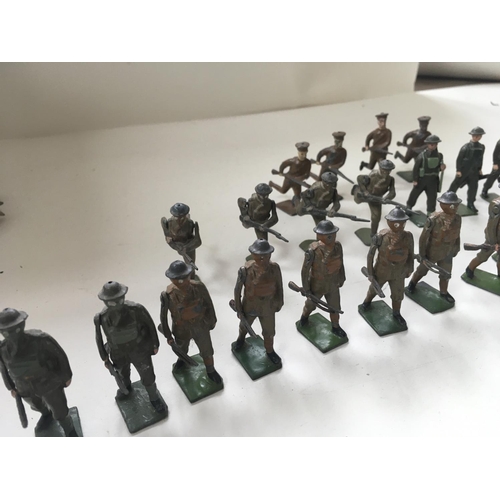 509 - A collection of 23 metal toy soldiers by Britains an another. 19 have moving arm and they are mainly... 