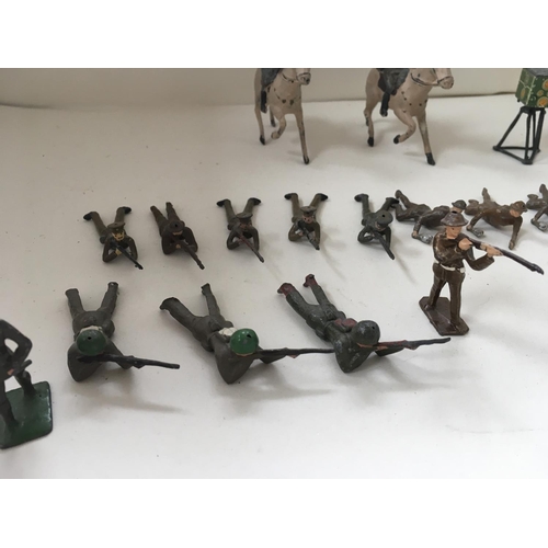 510 - A collection of metal soldiers in various poses in excess of 30 pieces. Manufacturer unclear.