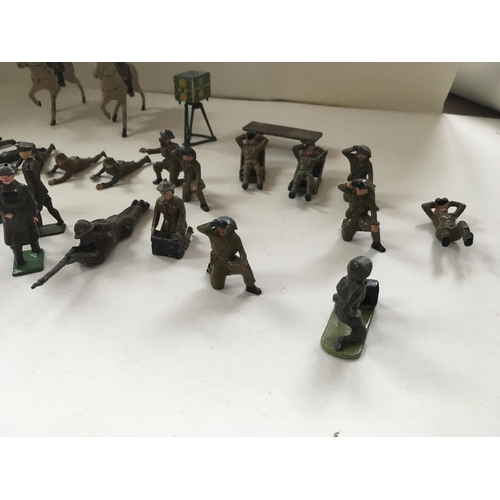 510 - A collection of metal soldiers in various poses in excess of 30 pieces. Manufacturer unclear.