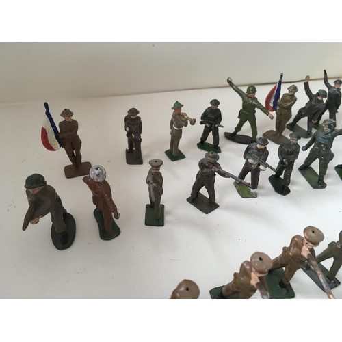 511 - A collection of 50 metal soldiers by Britains and others in assorted poses.