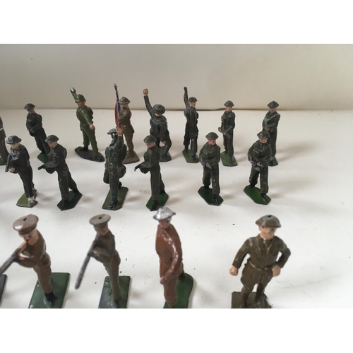 511 - A collection of 50 metal soldiers by Britains and others in assorted poses.