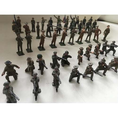 511 - A collection of 50 metal soldiers by Britains and others in assorted poses.