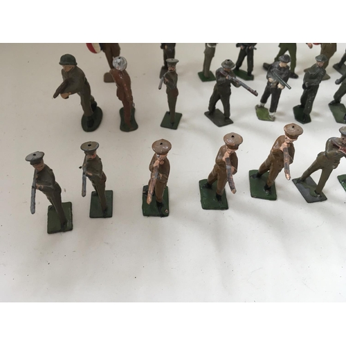 511 - A collection of 50 metal soldiers by Britains and others in assorted poses.