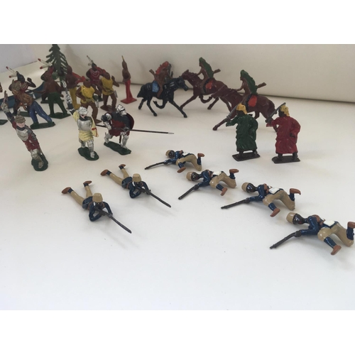 518 - A collection of lead figures mainly by Britains ltd. Themes are American Indians..medieval and Arabi... 