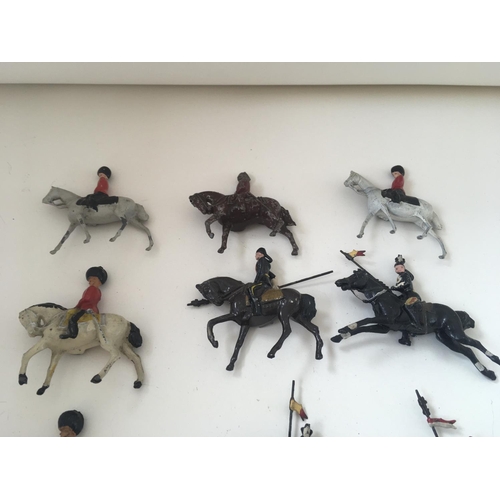 520 - A collection of 14 lead figures by Britains and others. Theme of mounted soldiers