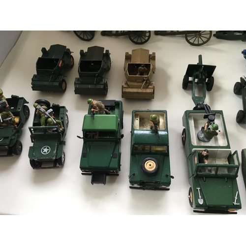 524 - A collection of 24 Playworn diecast model military vehicles by Britains and others.