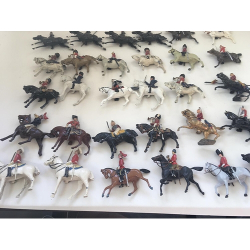 538 - A collection of 30 metal mounted soldiers from differing regiments. Manufactured mainly by Britains.... 