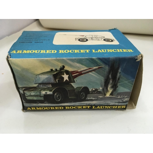 705 - Vintage boxed toys including a tin tank. 2x Artillery guns and a mobile rocket launcher.