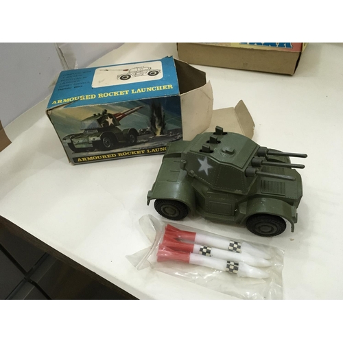 705 - Vintage boxed toys including a tin tank. 2x Artillery guns and a mobile rocket launcher.