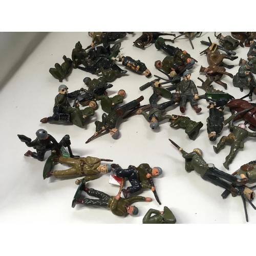 715 - A collection of approximately 50 metal soldier figures by Britains. Mostly from WW Numerous machine ... 