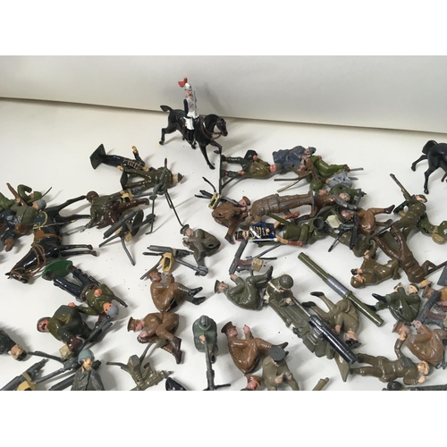 715 - A collection of approximately 50 metal soldier figures by Britains. Mostly from WW Numerous machine ... 