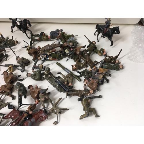 715 - A collection of approximately 50 metal soldier figures by Britains. Mostly from WW Numerous machine ... 