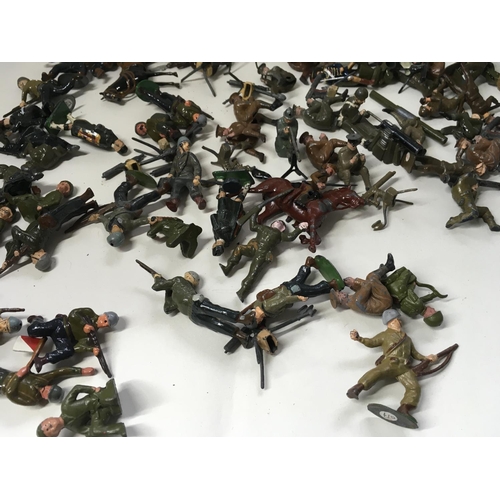 715 - A collection of approximately 50 metal soldier figures by Britains. Mostly from WW Numerous machine ... 