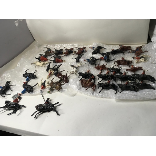 725 - A collection in excess of 35 model metal mounted soldiers by Britains. Hillco and others.