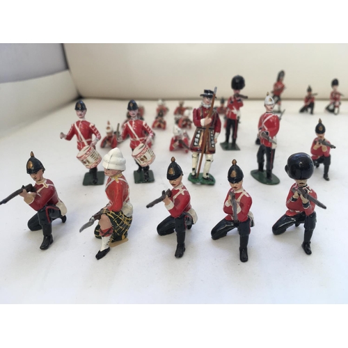 746 - A collection of 30 metal soldiers mainly Britains. Features differing regiments eras and stances.