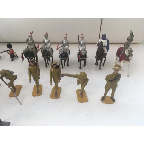 747 - A Collection of 25 metal figures by Britains and others. Includes soldiers. Mounted knights from a v... 