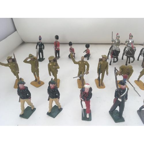 747 - A Collection of 25 metal figures by Britains and others. Includes soldiers. Mounted knights from a v... 