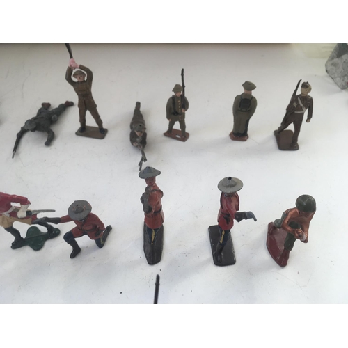 748 - A collection of 25 metal figures by Britains and others. All military themed.