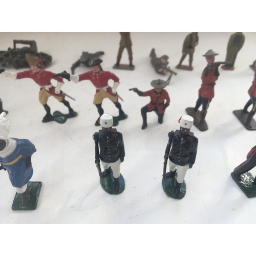 748 - A collection of 25 metal figures by Britains and others. All military themed.