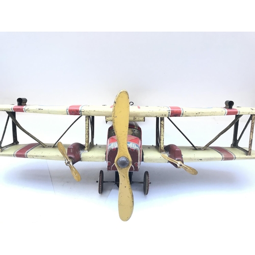 751 - A Vintage Tin plate Clockwork Bi-Plane. Seen Working. Approx length 47Cm and 51Cm wing span.