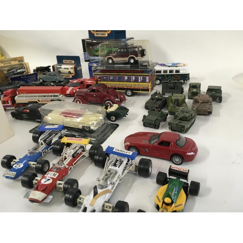 879 - A collection of model vehicles by assorted manufacturers both boxed and Playworn, includes some mili... 