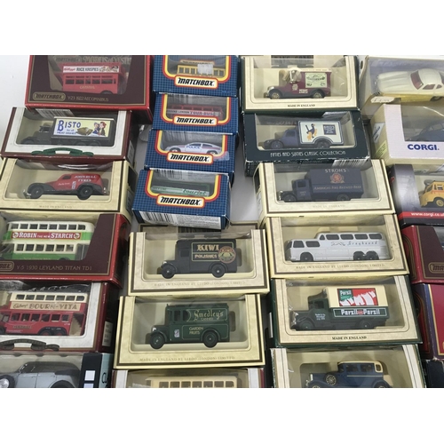 882 - A collection in excess of 60 model cars by a variety of manufacturers mostly in original packaging