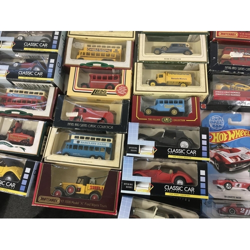 882 - A collection in excess of 60 model cars by a variety of manufacturers mostly in original packaging