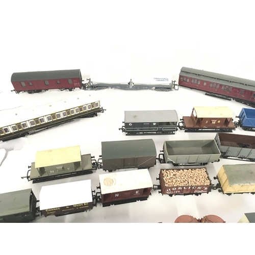 889 - A collection in excess of 35 00 gauge railway wagons and carriages all unboxed.