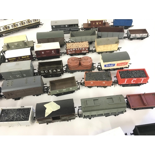 889 - A collection in excess of 35 00 gauge railway wagons and carriages all unboxed.