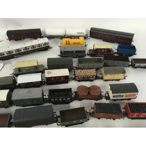 889 - A collection in excess of 35 00 gauge railway wagons and carriages all unboxed.