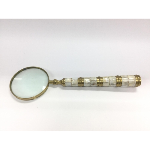 10 - A large brass and mother of pearl handled magnifying glass. NO RESERVE. Shipping category D.