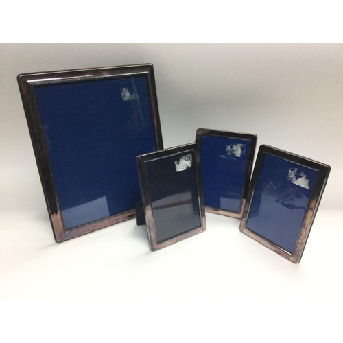 12 - Four silver plated photo frames comprising one larger, approx 24cm x 29cm, plus three smaller (4). N... 